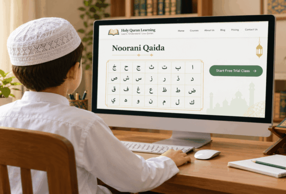Young boy in white shalwar kameez and cap learning Noorani Qaida online on Holy Quran Learning